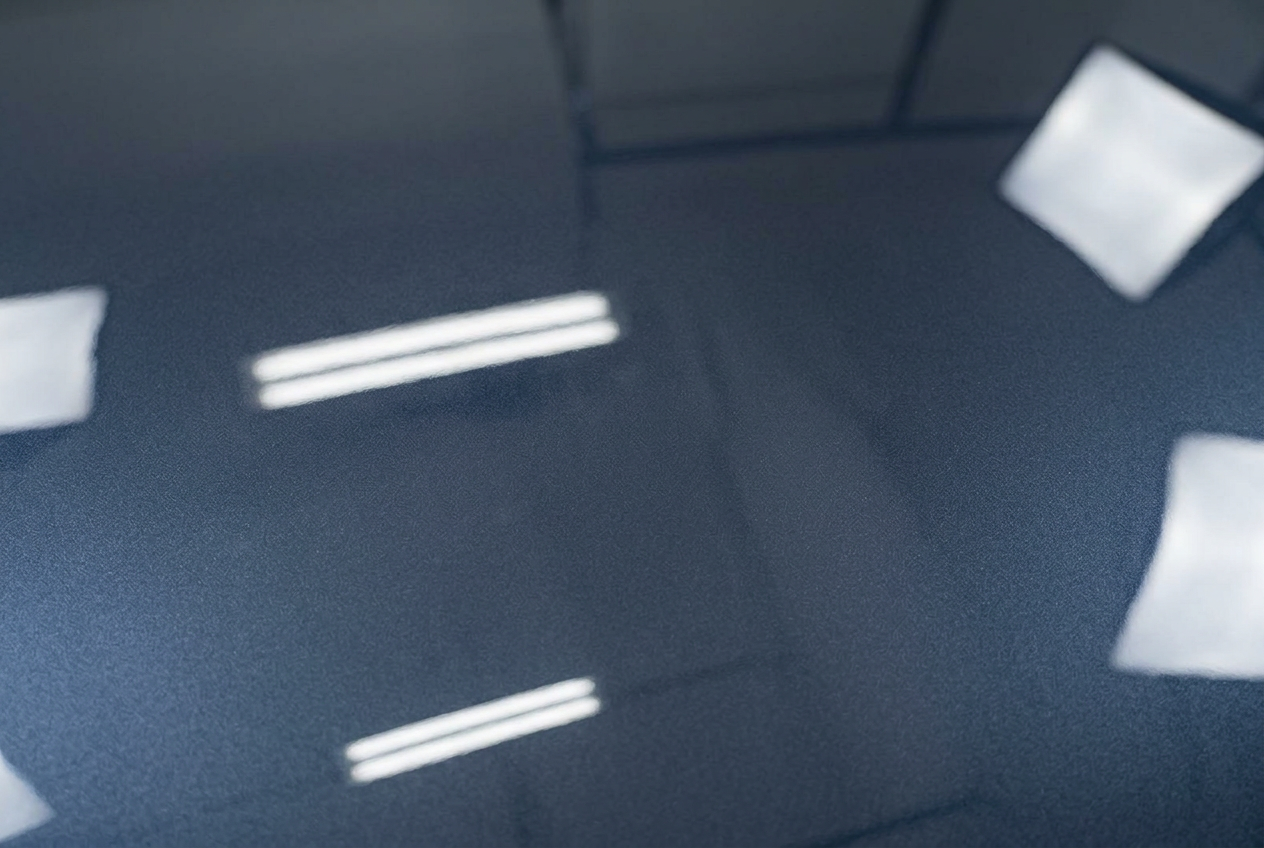 The same dark blue panel after correction, deep and mirror-glossy